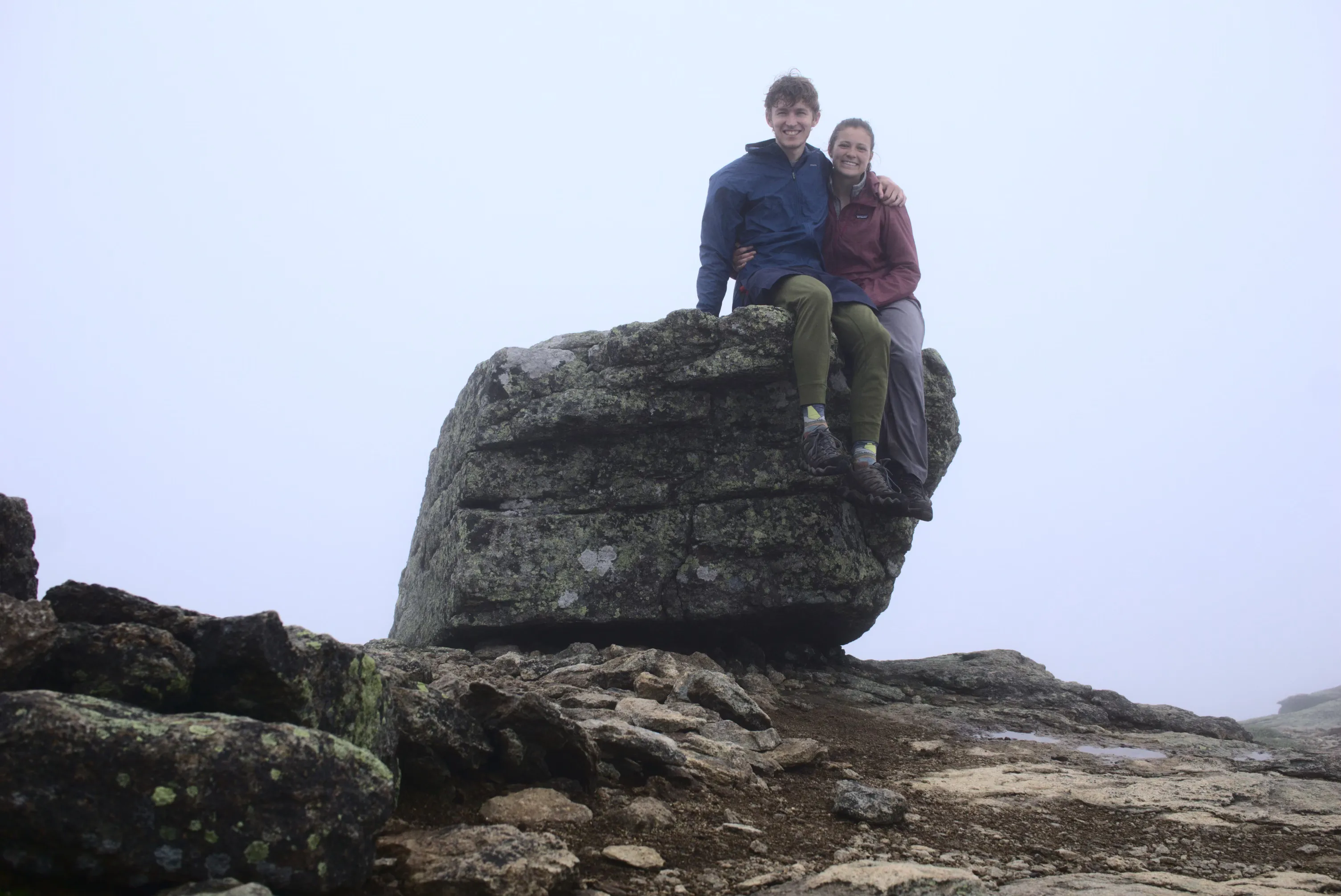 Naomi and Ben sitting on rock in fog