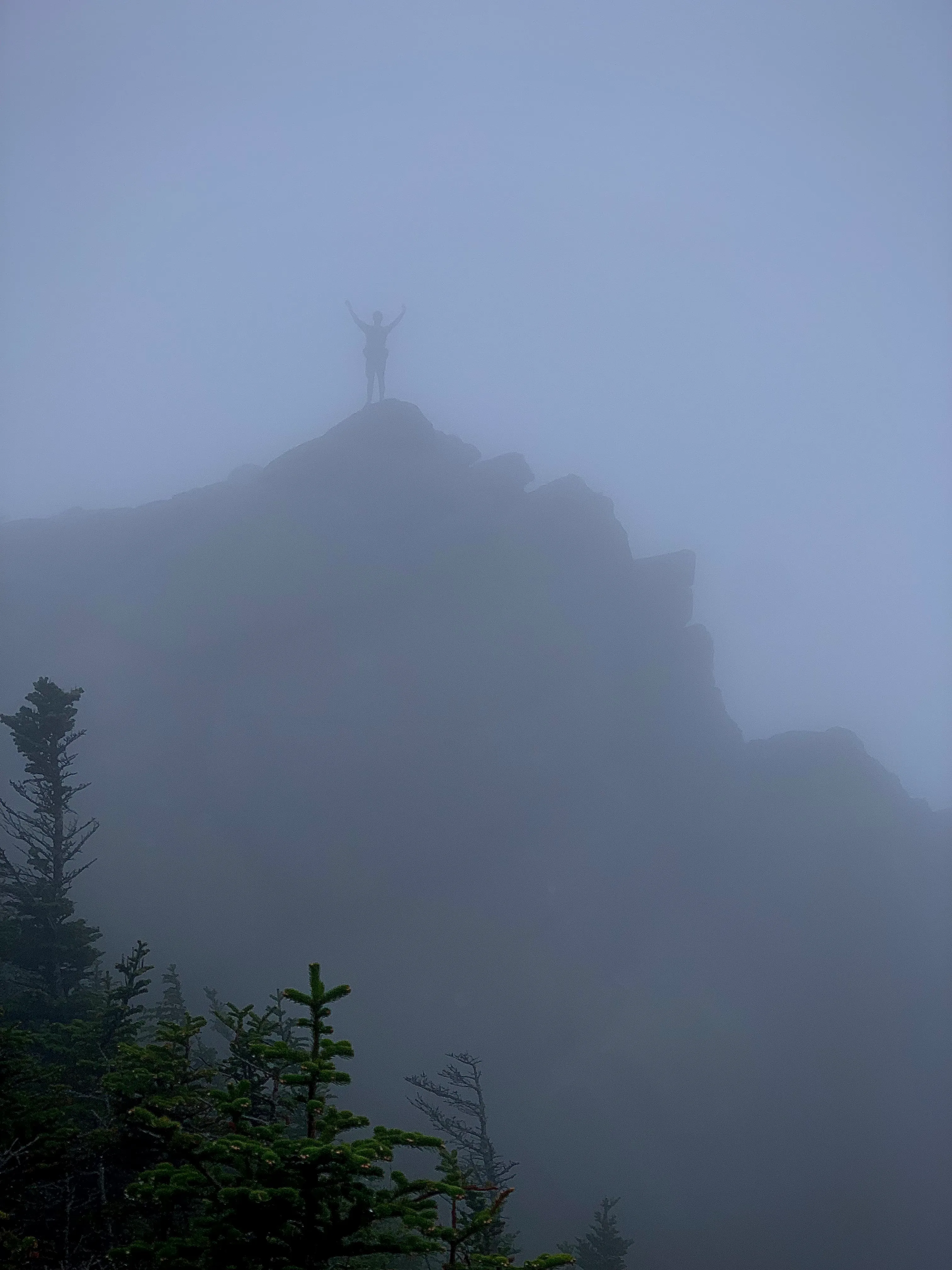 Ben standing on rock in fog