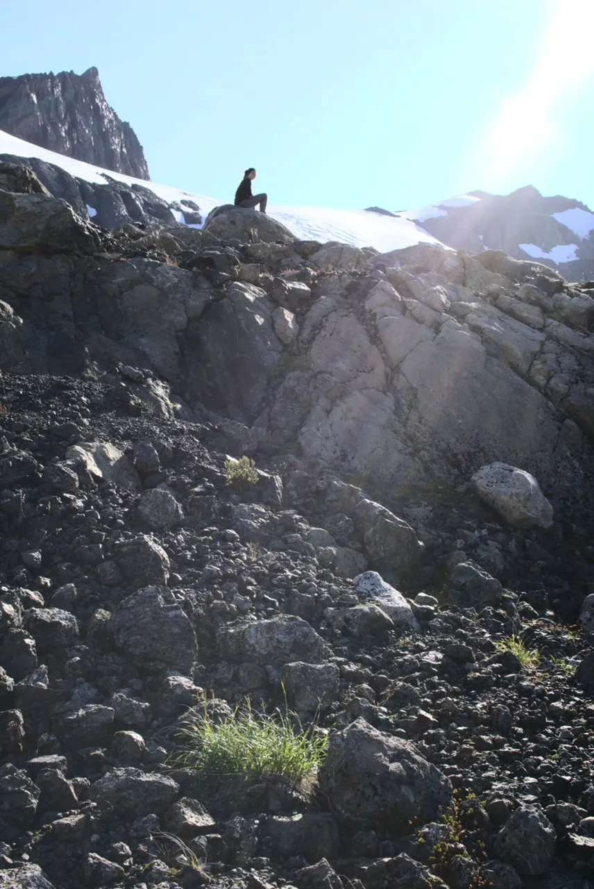 Naomi sitting on a rock